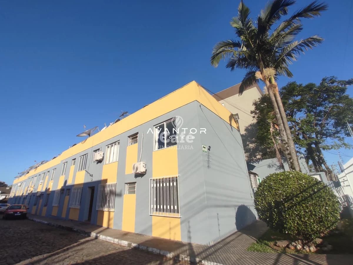 Fachada do prédio com amarelo e branco — Apartamento com 2 quartos à venda em Nossa Senhora de Lourdes, Santa Maria/RS