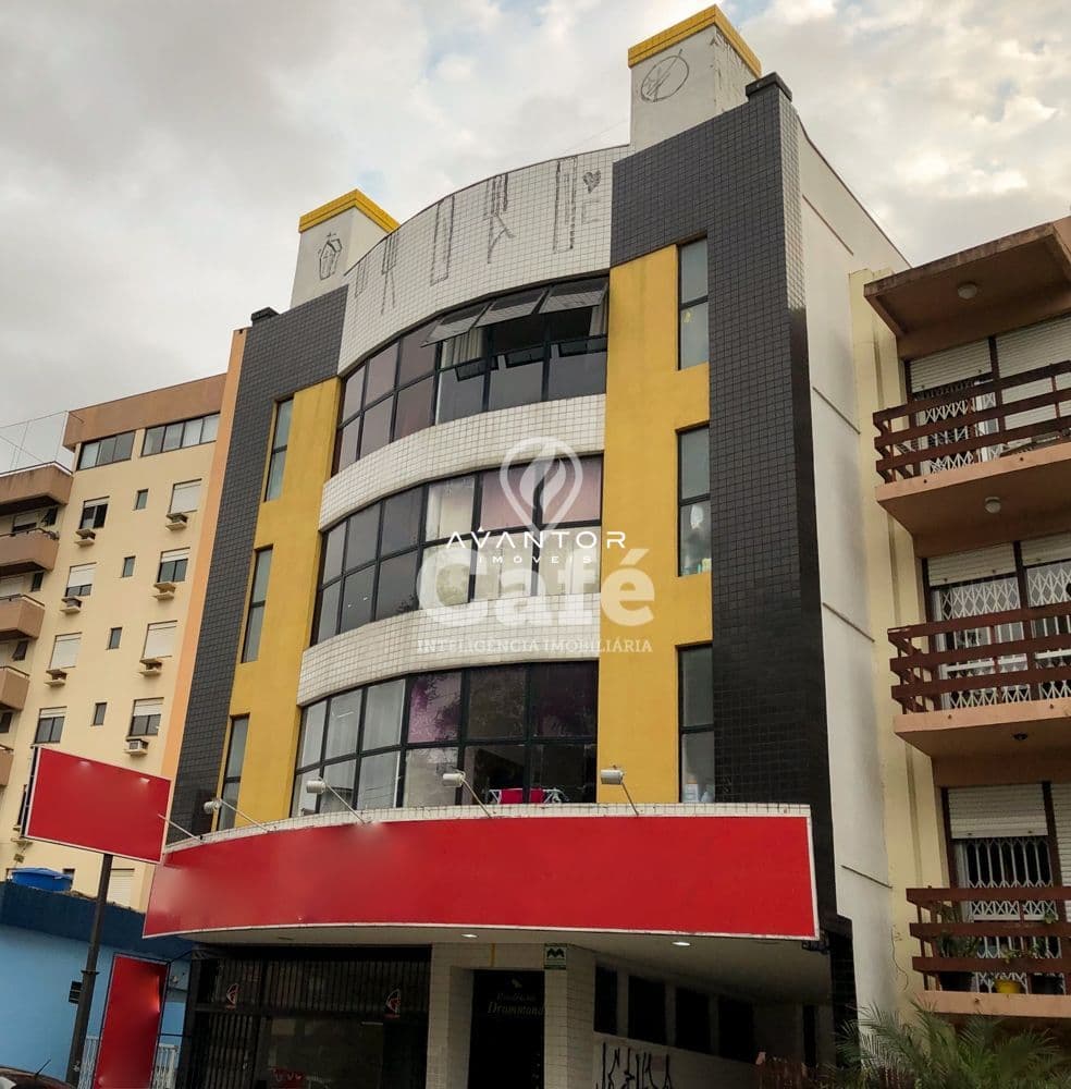 Fachada do prédio com detalhes em amarelo — Apartamento com 1 quarto à venda em Centro, Santa Maria/RS