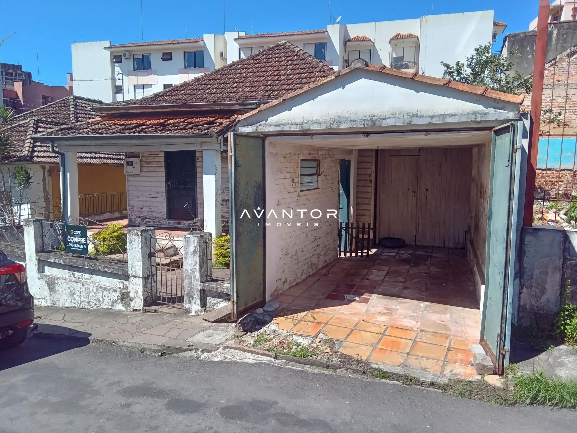 Fachada da casa com garagem — Terreno à venda em Centro, Santa Maria/RS
