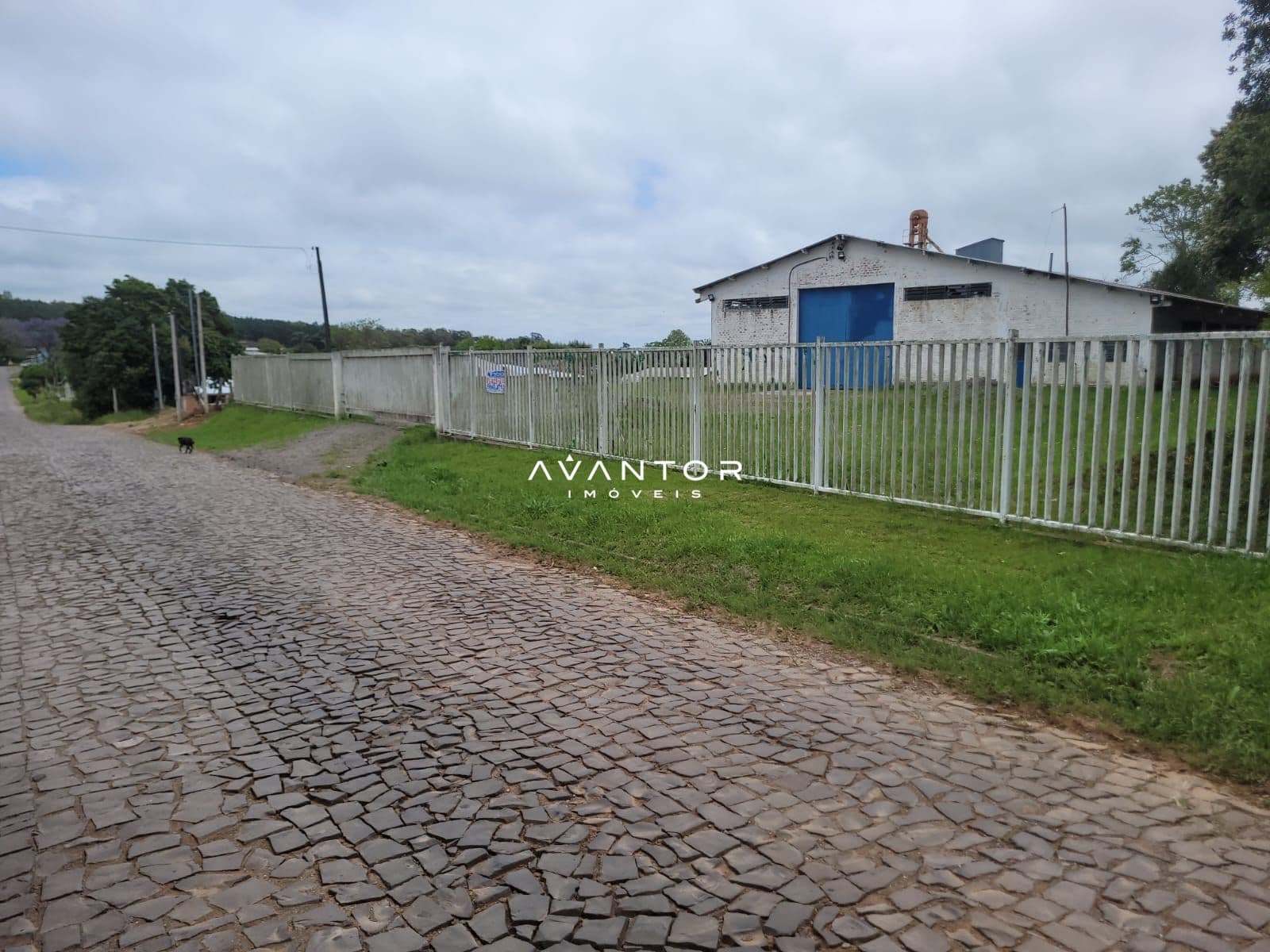 Fachada da casa com portão branco — Pavilhão com 1 sala à venda em Centro, Itaara/RS