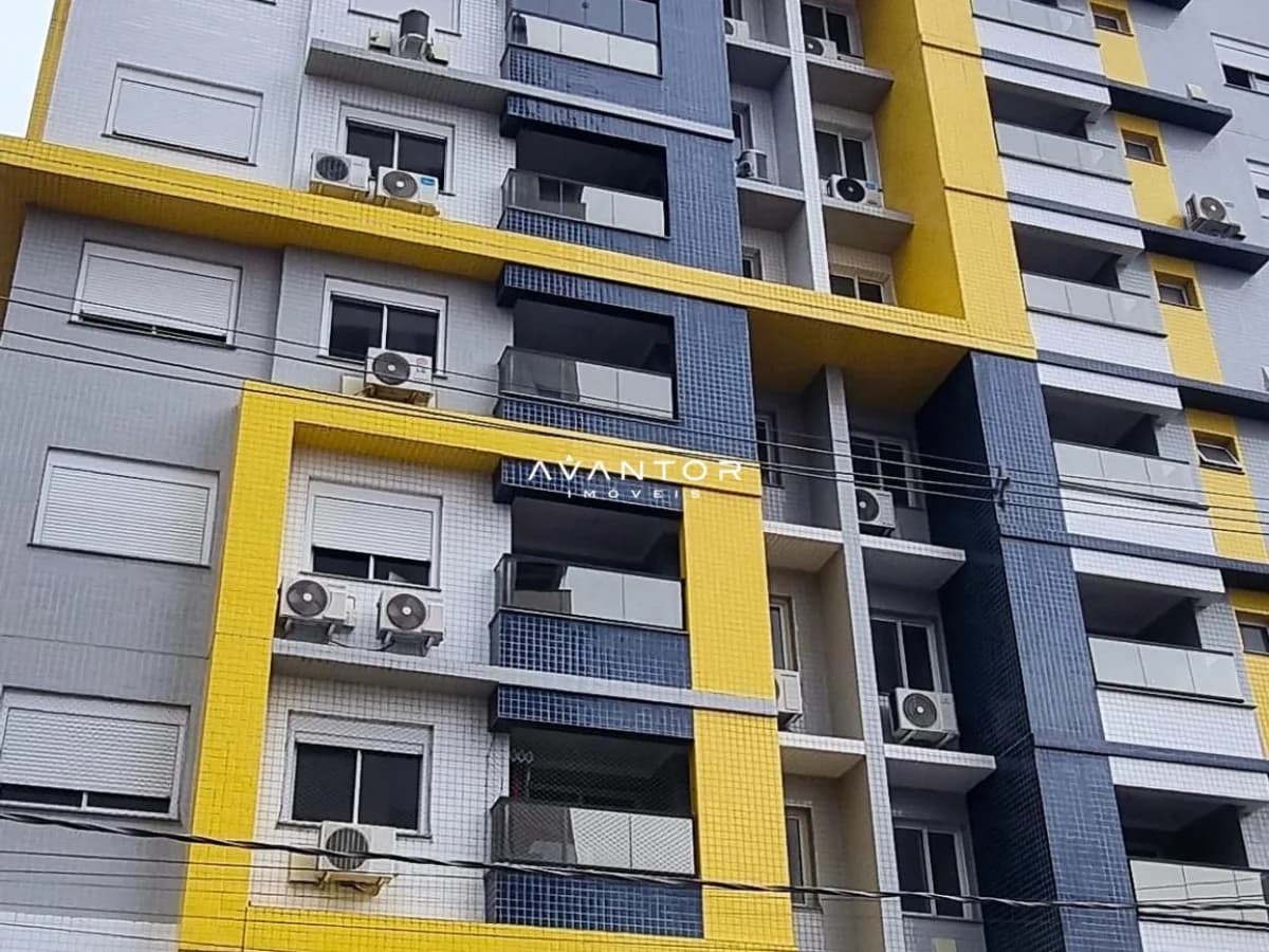 Fachada do prédio com detalhes em amarelo — Apartamento com 1 quarto à venda em Nossa Senhora de Fátima, Santa Maria/RS